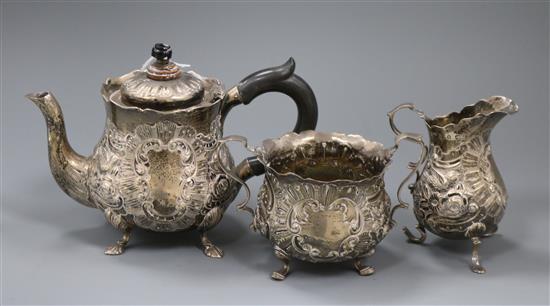 A late Victorian emobssed silver three piece tea set, gross 18 oz.